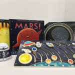 Three books on space with a inter active space board.